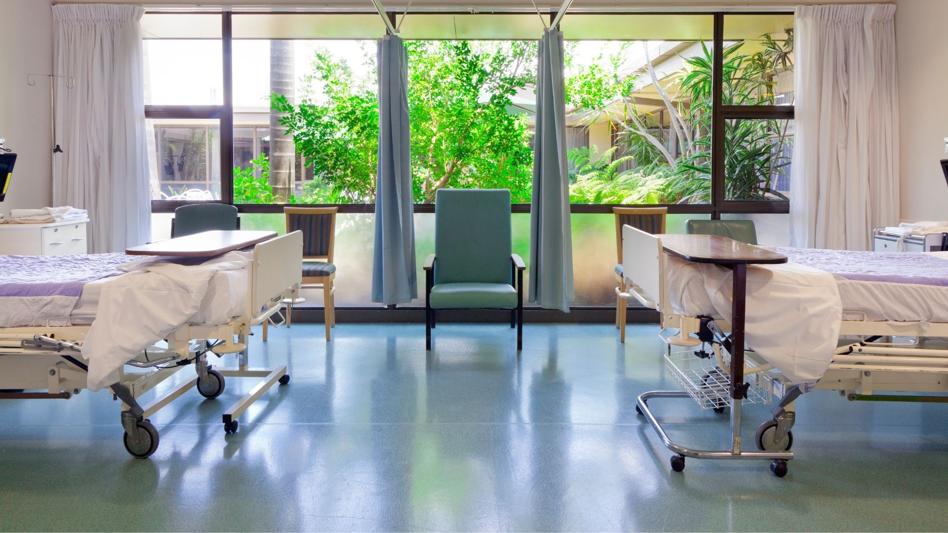 Clean hospital patient room with sanitised beds and floors following professional healthcare cleaning.